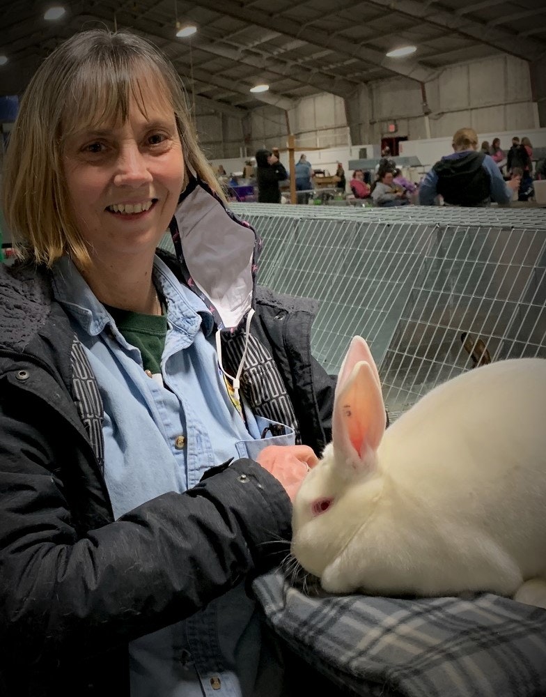 May contain: person, human, clothing, apparel, rabbit, animal, rodent, bunny, and mammal