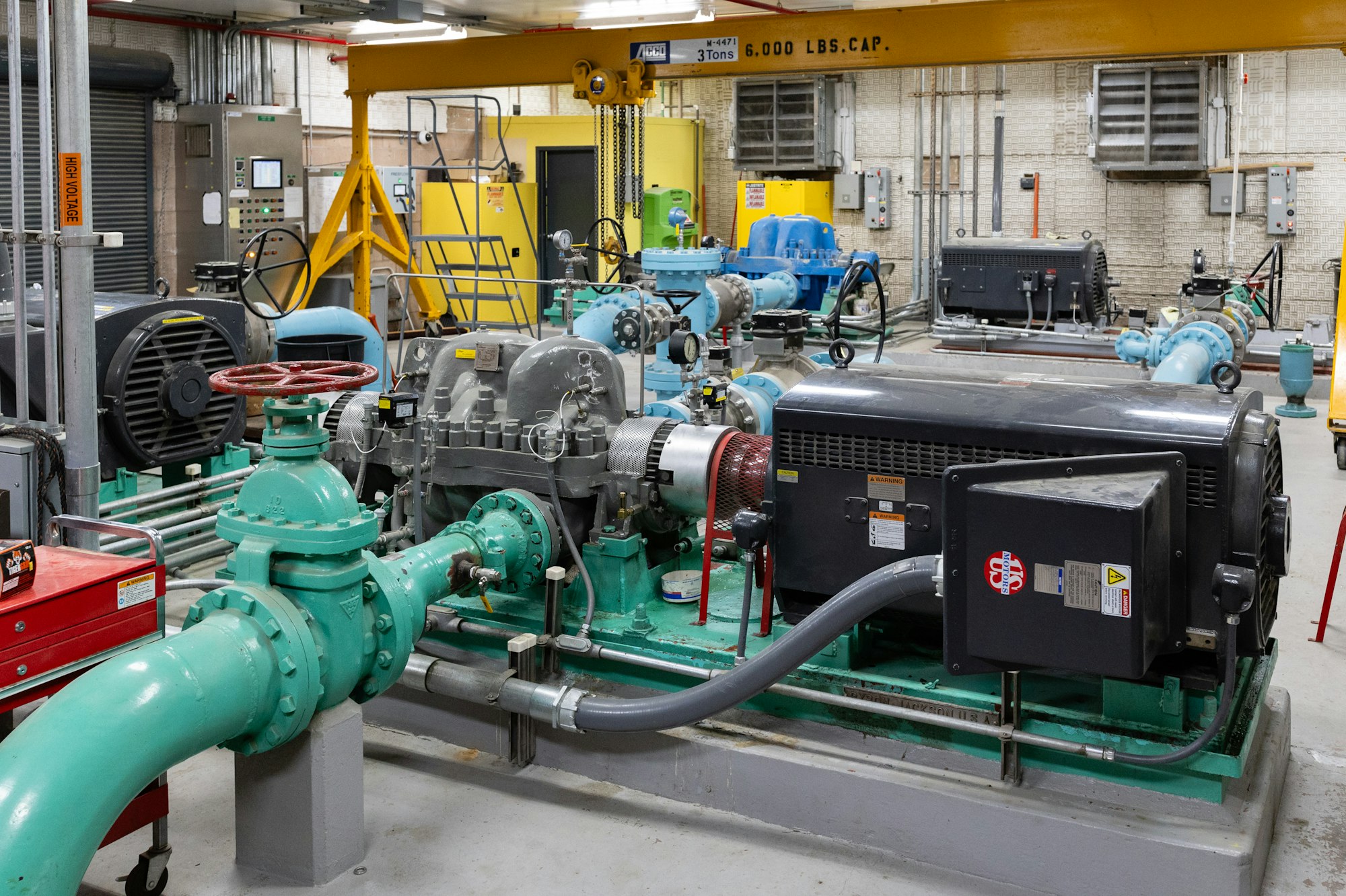 Inside of Luther Pass Pump Station with pumps, motors, and pipes.