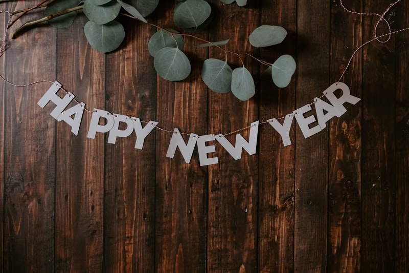 Happy New Year sign with a wooden background