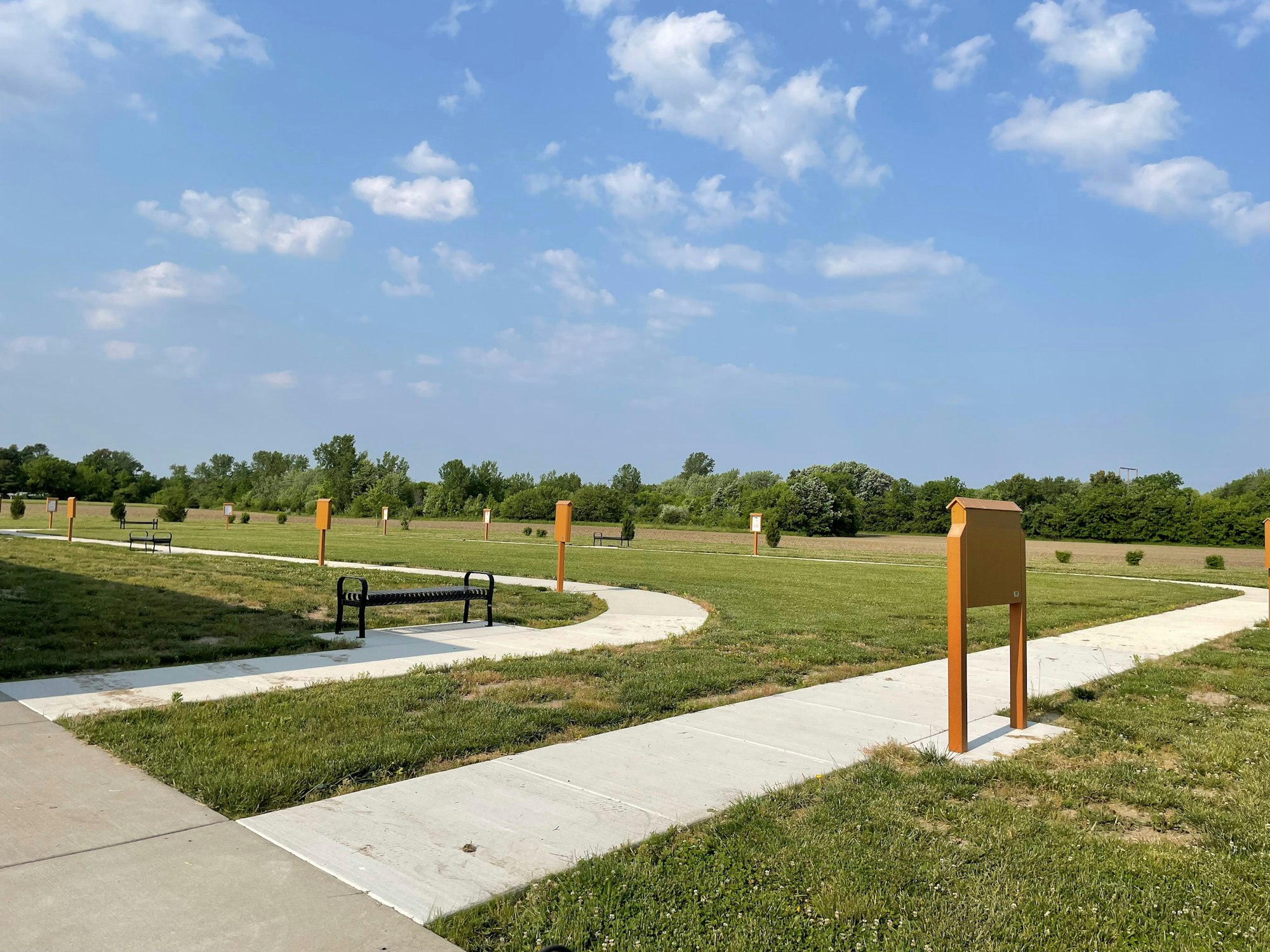 May contain: grass, nature, outdoors, park, plant, bench, furniture, and path