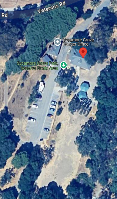 Aerial view of Sycamore Grove Park showing parking, picnic area, and ranger office with surrounding trees.