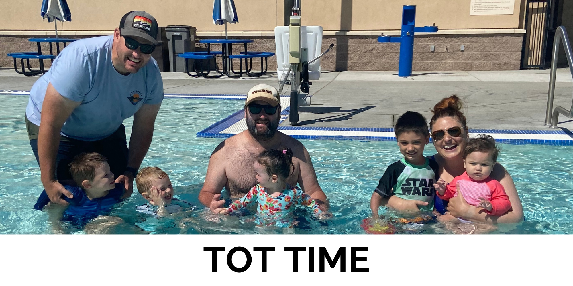 A fun pool scene with adults and kids enjoying "Tot Time" together. Smiles and laughter all around!