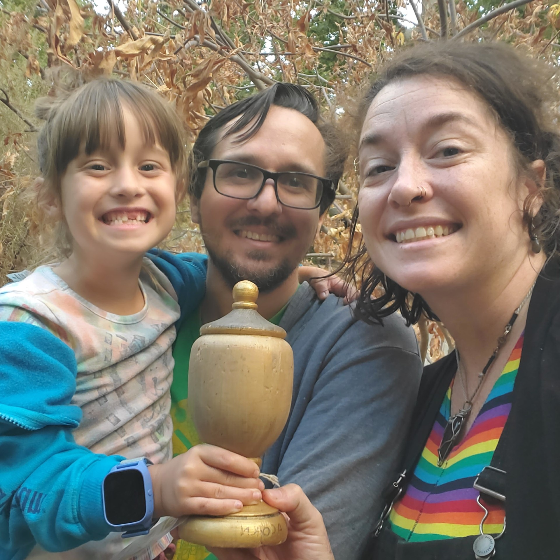 May contain: face, head, person, photography, portrait, pottery, jar, accessories, glasses, plant, vegetation, jewelry, necklace, happy, smile, tree, adult, female, woman, and potted plant