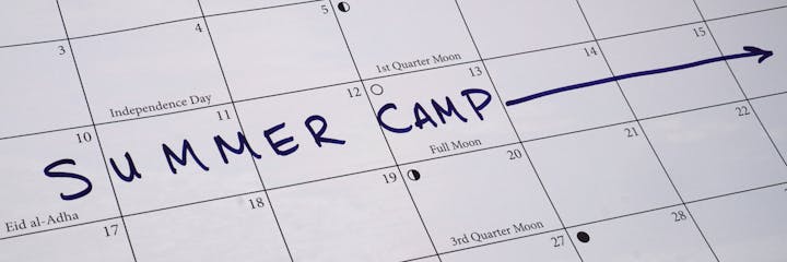 A calendar page with "SUMMER CAMP" written prominently, indicating a scheduled event, along with dates and holidays.