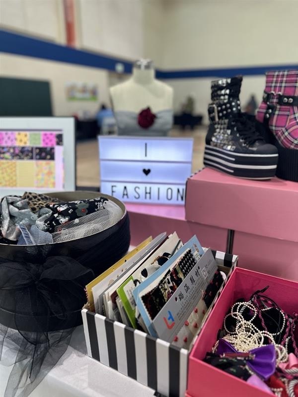 A display featuring fashion items, including a mannequin, trendy shoes, accessories, and a sign that says "I ♥ FASHION."