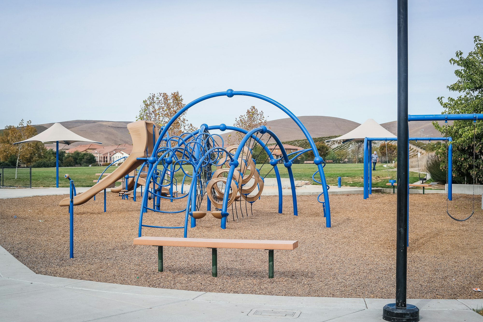 May contain: outdoor play area, outdoors, play area, person, bench, and furniture