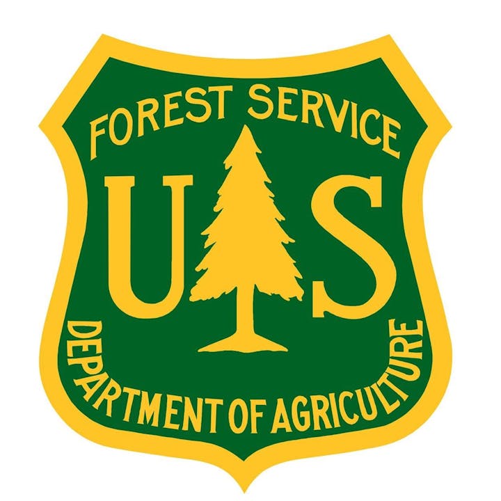 US Forest Service emblem featuring a tree, with "Department of Agriculture."