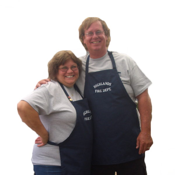 Two smiling people wearing aprons; one apron reads "Highlands Fire Dept." White background.