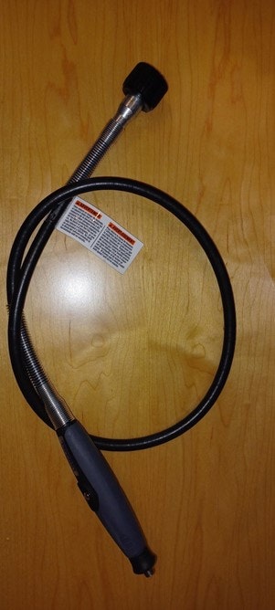 A flexible gooseneck inspection camera with a handle and attached label.