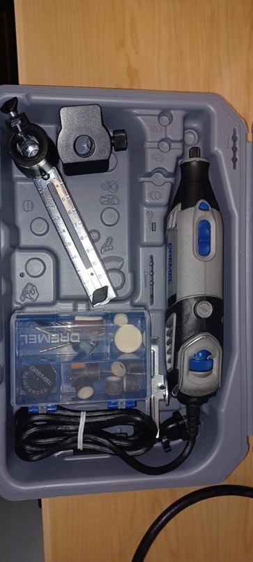 Dremel rotary tool kit with attachments and accessories in a plastic case.