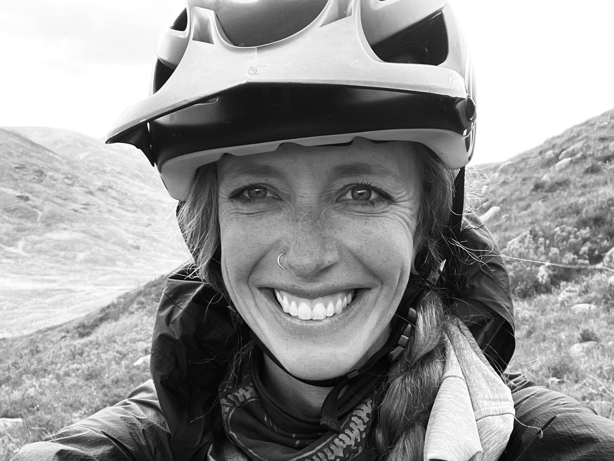 May contain: helmet, clothing, hardhat, face, head, person, photography, portrait, crash helmet, adult, female, woman, happy, smile, coat, and jacket