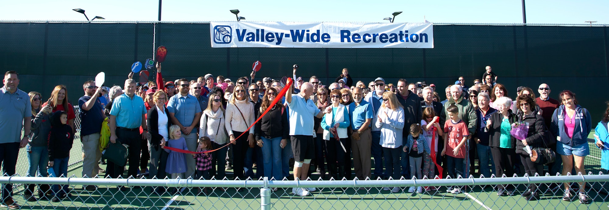 A large group of people gathered for a ribbon-cutting event at Valley-Wide Recreation, celebrating a new facility or program.