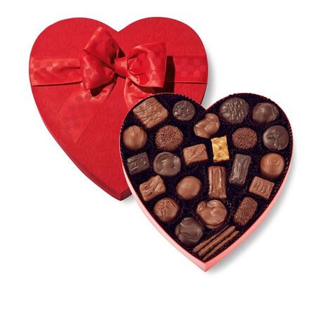 A red heart-shaped box filled with assorted chocolates and a bow on top. Perfect for gifts or special occasions!