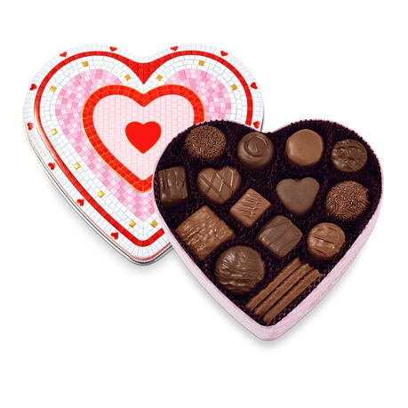 A heart-shaped box filled with assorted chocolates, featuring various shapes and textures. Perfect for gifts!