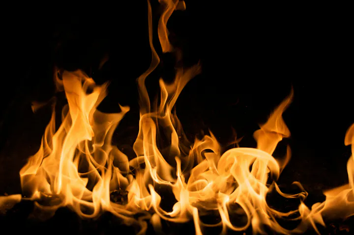 Dancing orange flames against a dark background.