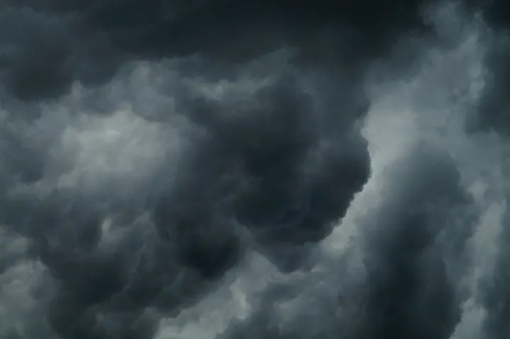 The image shows a dramatic sky filled with dark, swirling clouds, suggestive of an impending storm.