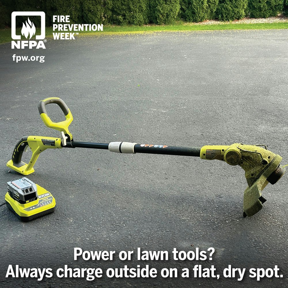 A string trimmer and battery charger on pavement with NFPA Fire Prevention Week advice to charge outside safely.