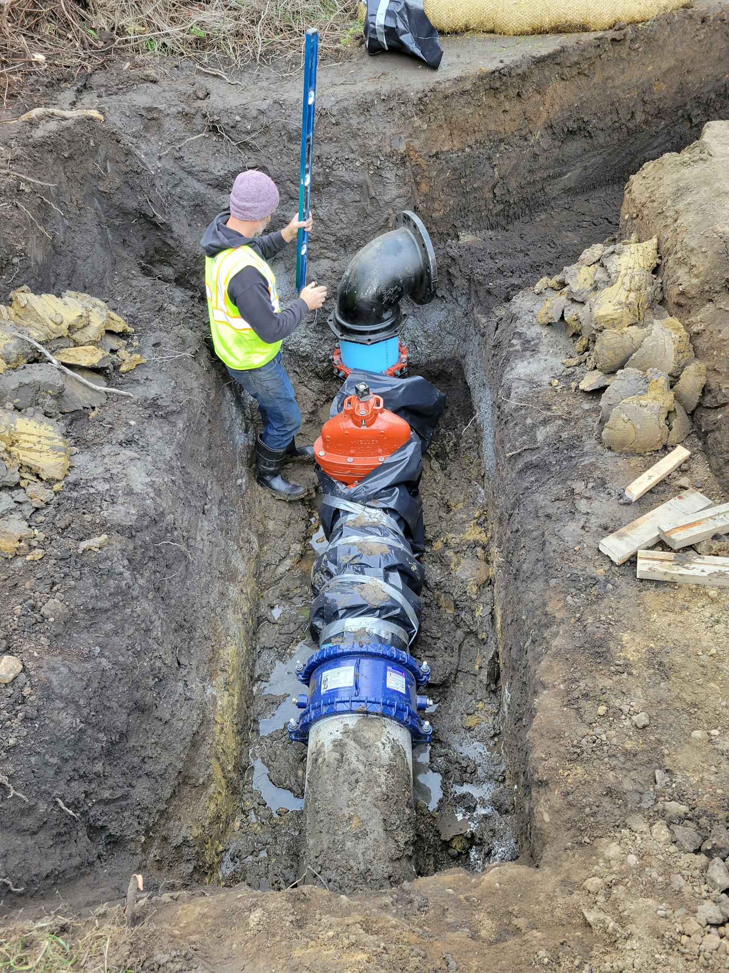 May contain: person, human, clothing, apparel, soil, helmet, and hardhat