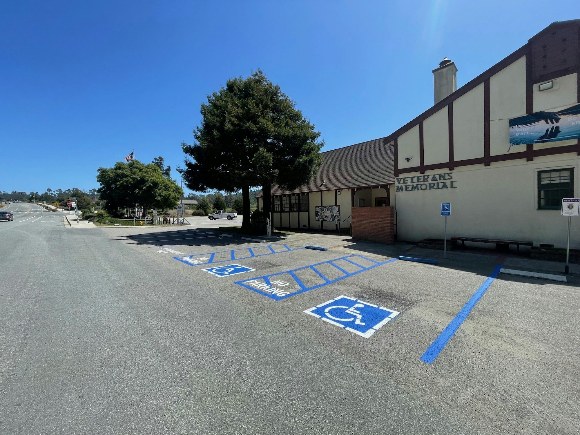 A Veterans Memorial building with a parking area showing accessible parking spots under a clear sky.