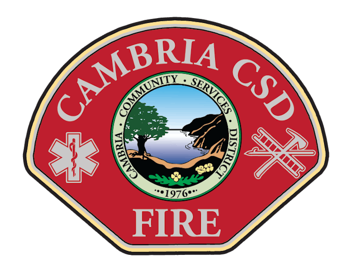 A badge with text "Cambria CSD Fire" and symbols including a tree, ocean, and fire service icons.