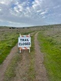 May contain: path, nature, outdoors, trail, sign, and symbol