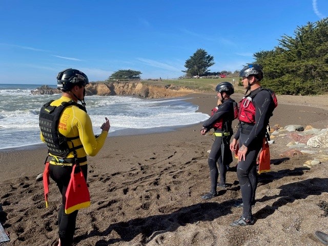 May contain: person, human, lifejacket, vest, clothing, apparel, shoreline, water, outdoors, sea, nature, and ocean