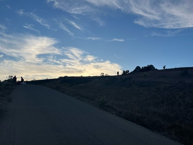 May contain: road, nature, outdoors, sky, slope, tarmac, scenery, horizon, person, freeway, highway, landscape, and cloud