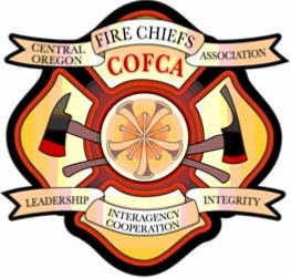 Emblem for Central Oregon Fire Chiefs Association (COFCA) with fire axes and values: Leadership, Integrity, Cooperation.