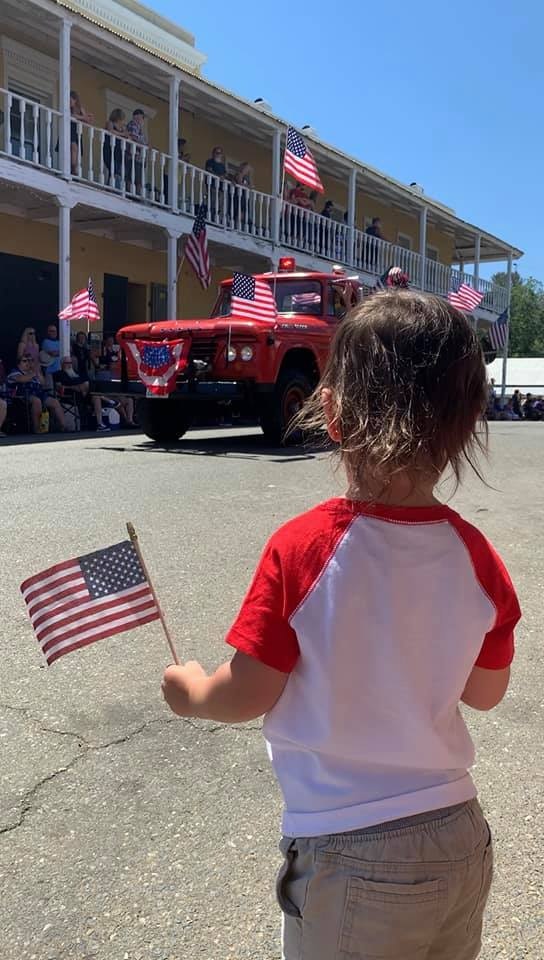 May contain: person, human, flag, symbol, truck, vehicle, and transportation