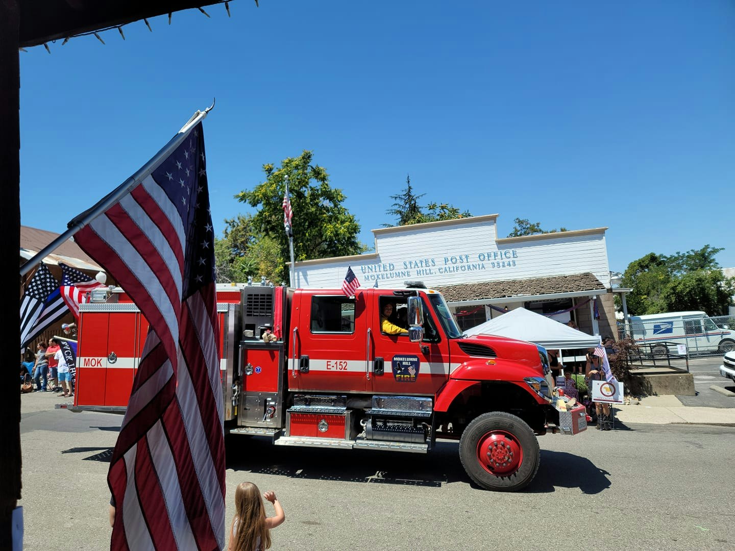 May contain: person, human, truck, vehicle, transportation, flag, and symbol