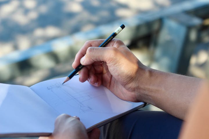 May contain: body part, finger, hand, person, writing, and pen