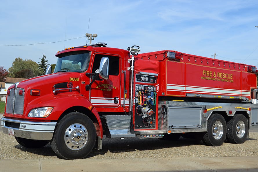 A red fire and rescue truck labeled "Northern Pratt Co. Fire Prot. Dist." is parked outside.