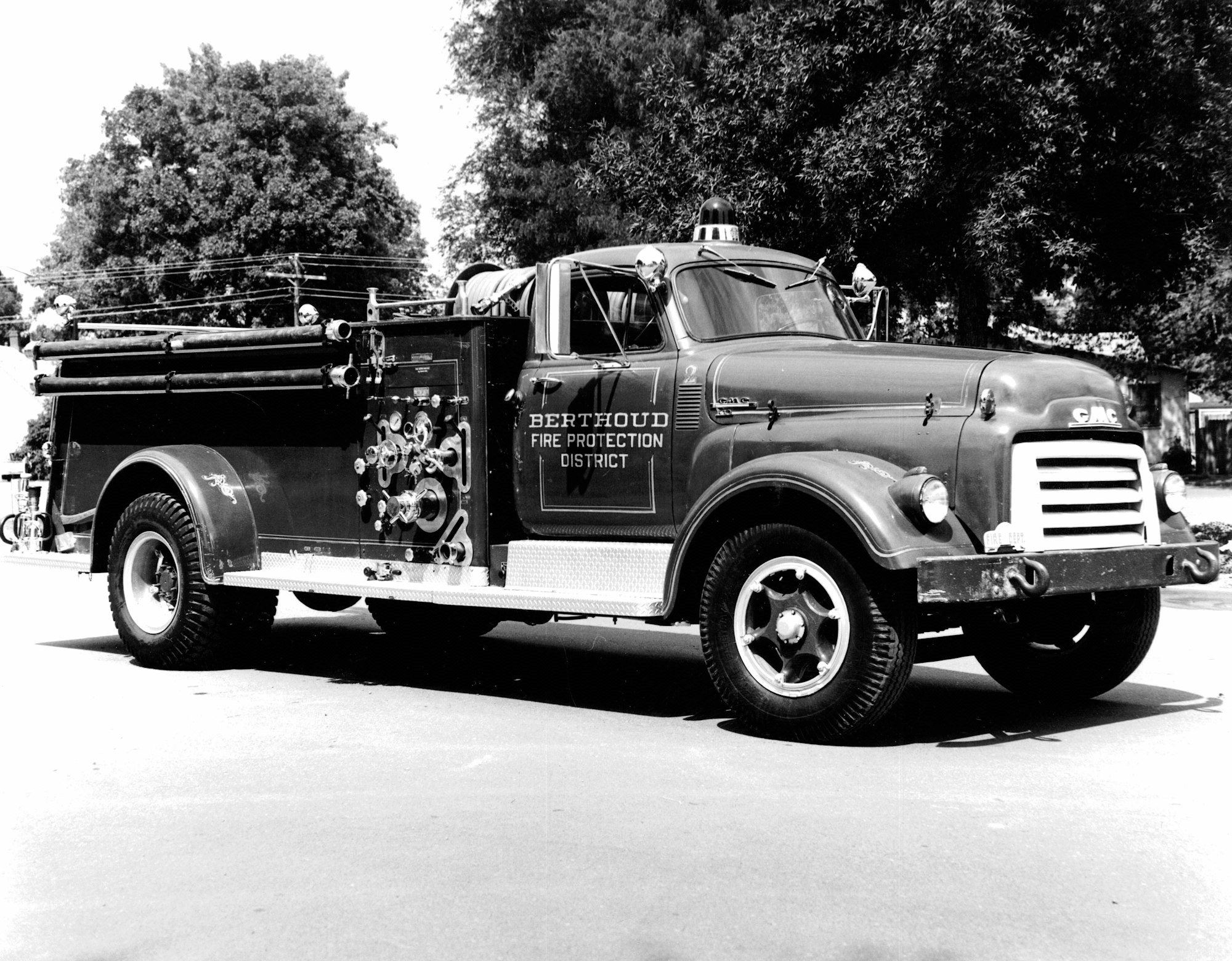 The image features a vintage fire truck, likely from the mid-20th century, marked for the Berthoud Fire Protection District.