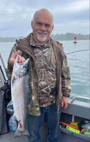 May contain: fishing, leisure activities, outdoors, water, animal, coho, fish, sea life, person, and angler