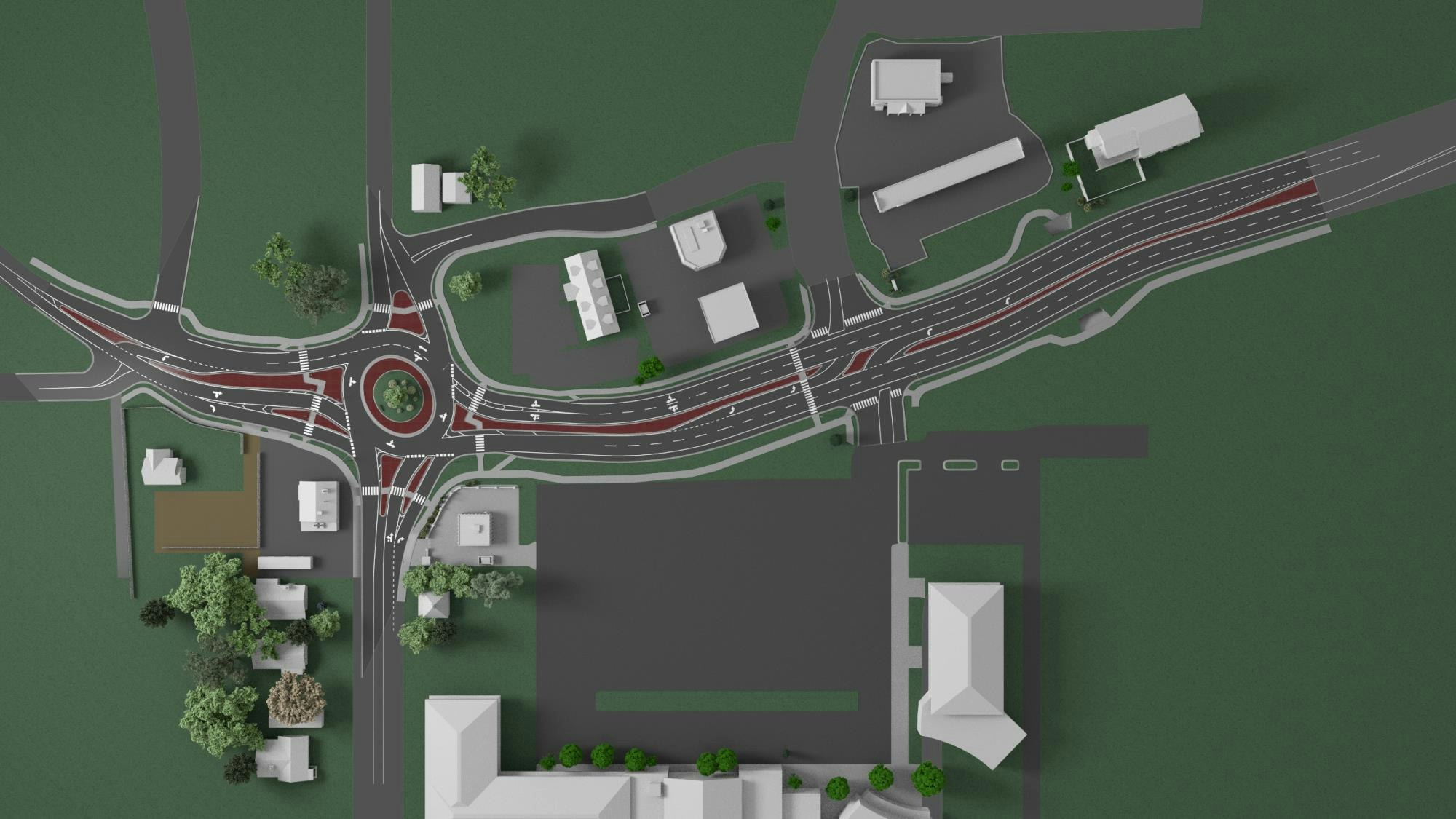 Aerial view of a roundabout with roads, buildings, and green spaces in an urban layout.