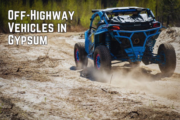 An off-highway vehicle kicks up dust while driving through a sandy area in Gypsum.