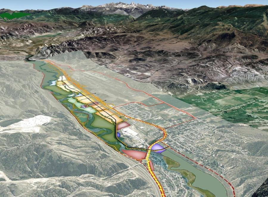 Aerial view of a mountain valley with a colorful developmental map overlay, indicating planned infrastructure or land use.