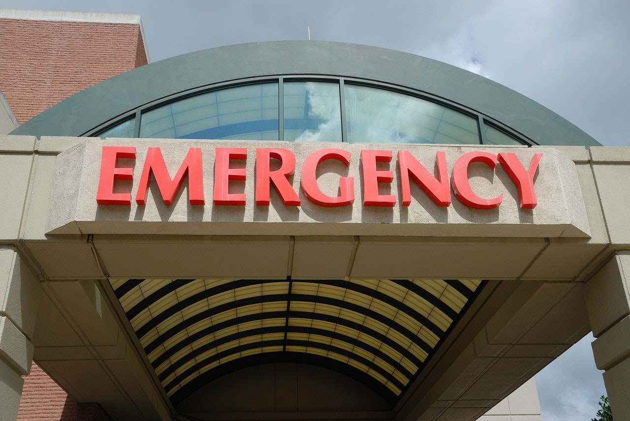 Red "EMERGENCY" sign above a hospital entrance.