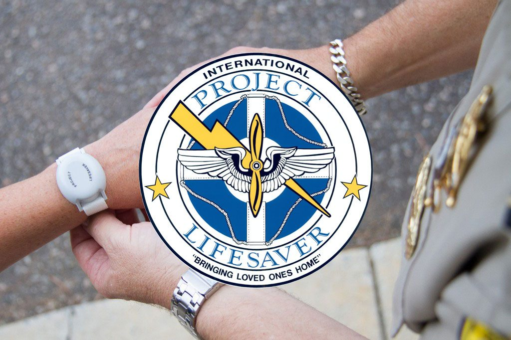 A person wearing a tracking bracelet with the "Project Lifesaver" emblem.