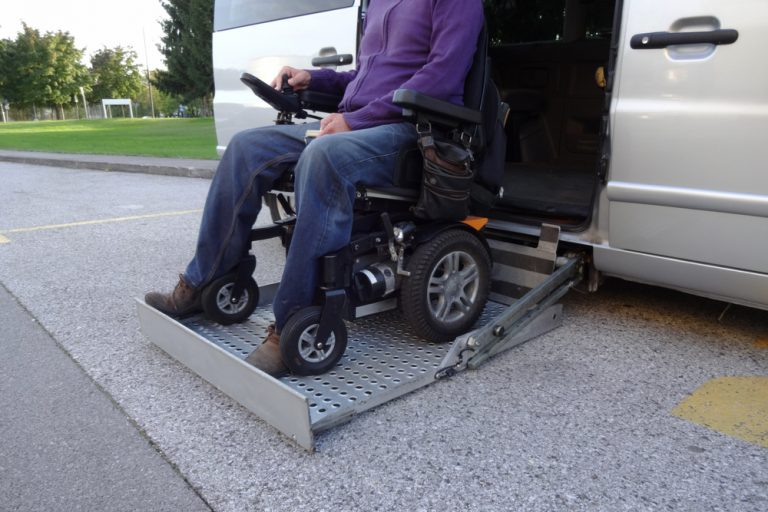 A person in a wheelchair using a vehicle lift.