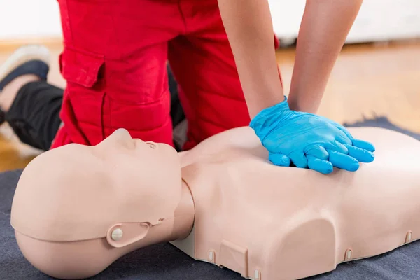 Performing CPR on a mannequin