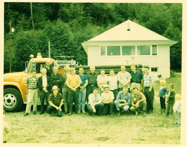 May contain: architecture, building, outdoors, shelter, people, person, clothing, pants, grass, plant, vegetation, face, head, photography, portrait, tree, hat, nature, yard, land, woodland, machine, wheel, jeans, soil, pickup truck, transportation, truck, and vehicle