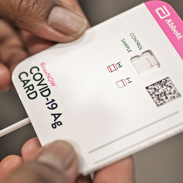 A COVID-19 rapid antigen test card showing a negative result.