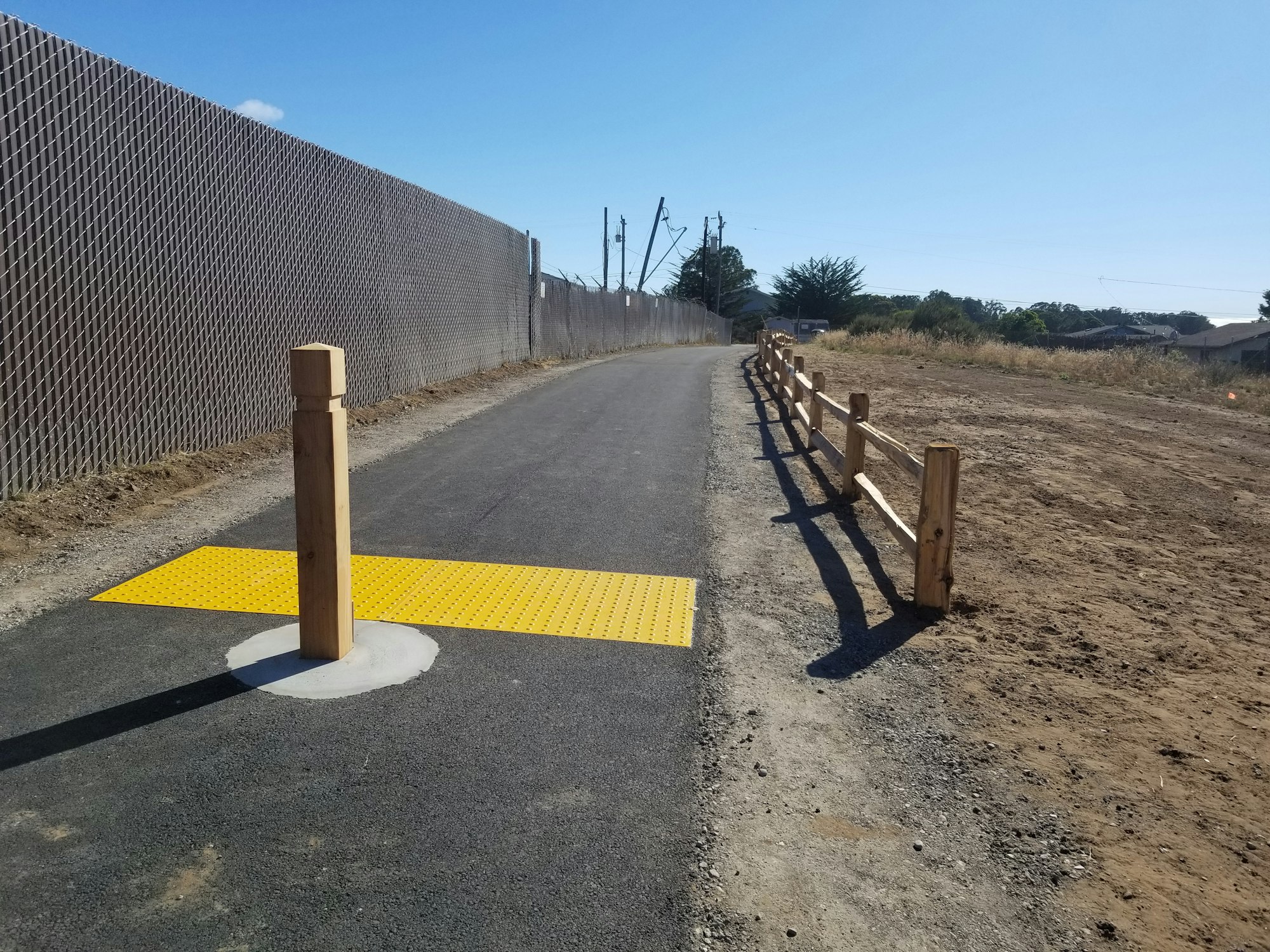 Ferrell Ave Pathway May contain: tarmac, asphalt, road and split-rail fence