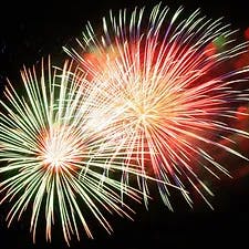 Colorful fireworks bursting against a dark sky.