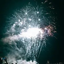 Bright fireworks against a night sky.