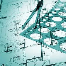 Blueprints with a ruler and a compass, suggesting architectural or engineering planning.