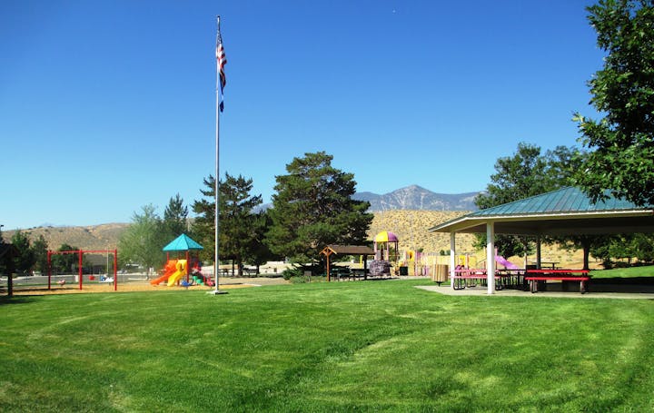 May contain: grass, plant, nature, outdoors, park, lawn, play area, outdoor play area, architecture, building, and shelter