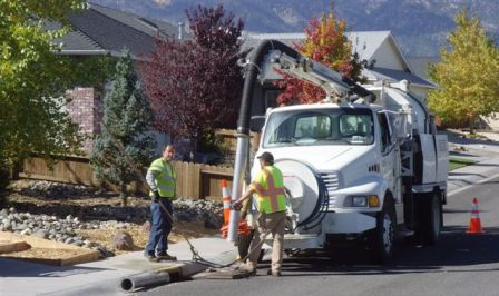 May contain: person, worker, city, road, street, urban, utility pole, adult, male, man, and neighborhood