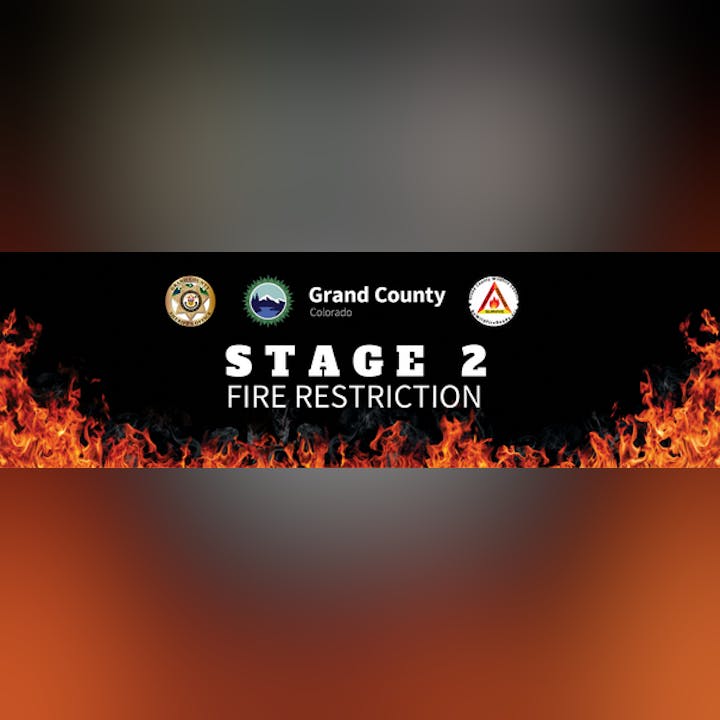 "Stage 2 Fire Restriction" notice with fire graphics, logos, and "Grand County Colorado" text.